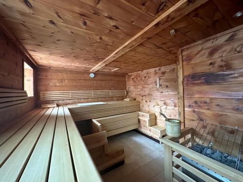 an empty wooden sauna with a bench in it at Hotel Enzian - Adults Only in Obertauern
