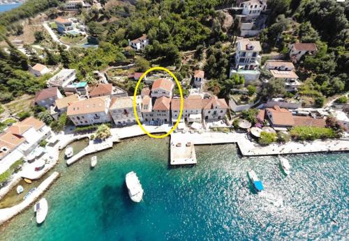 an aerial view of a house with a yellow circle at Rose - Apartmani Janovic in Lustica