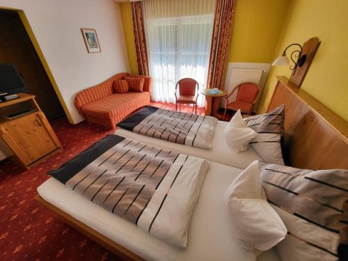 ein Schlafzimmer mit 2 Betten und ein Wohnzimmer in der Unterkunft Gästehaus Schwarz in Prien am Chiemsee