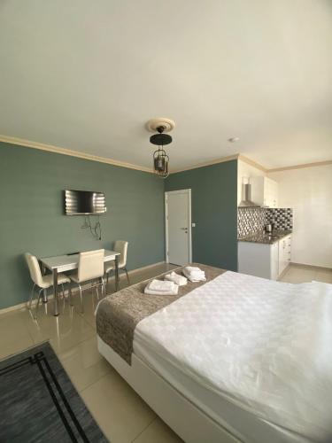 a bedroom with a bed and a table and chairs at Erbay Mansions Hotel in Trabzon