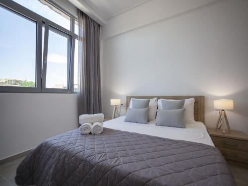 a bedroom with a large bed with two towels on it at Attalos luxury flat Psyrri square in Athens