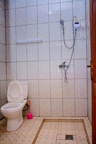 a bathroom with a shower and a toilet at IREBERO DREAM HOME in Kayonza