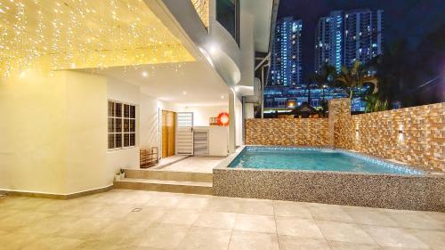 a swimming pool in a building with a city skyline at JB City Villa (Private Pool) in Johor Bahru