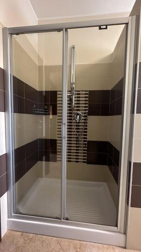 a shower with a glass door in a bathroom at Vacancuore, a casa di Giada in Bastia Umbra