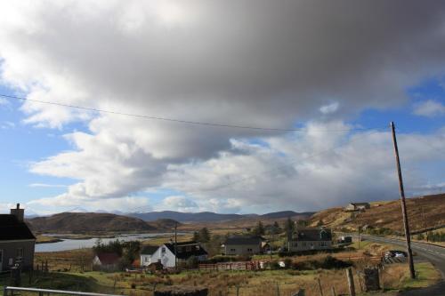 a view of a village with a river and mountains at Parcview #1 in Stornoway