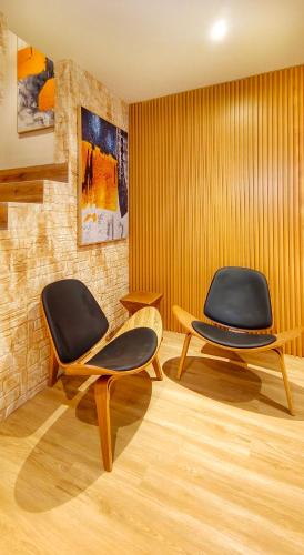 two chairs sitting in a room with yellow walls at JB City Villa (Private Pool) in Johor Bahru