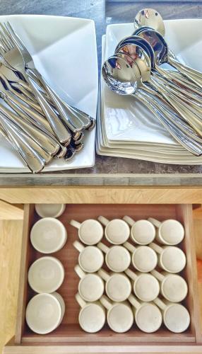 a table with utensils and a tray of food at JB City Villa (Private Pool) in Johor Bahru