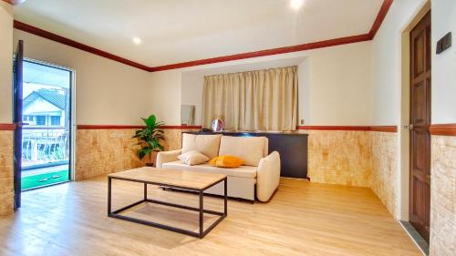 a living room with a couch and a table at JB City Villa (Private Pool) in Johor Bahru