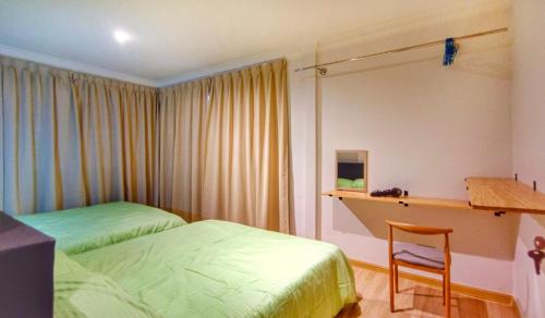 a bedroom with two beds and a desk and a chair at JB City Villa (Private Pool) in Johor Bahru
