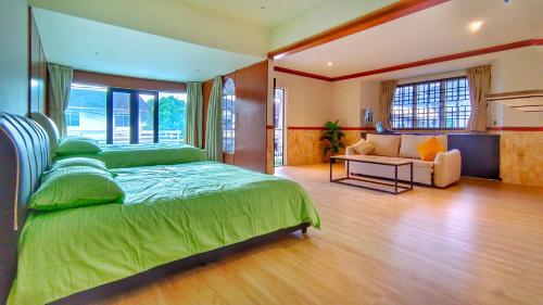 a bedroom with a bed and a couch in a room at JB City Villa (Private Pool) in Johor Bahru