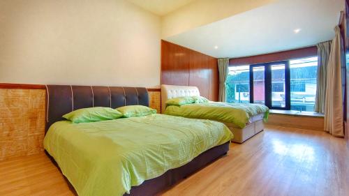 a bedroom with two beds and a window at JB City Villa (Private Pool) in Johor Bahru