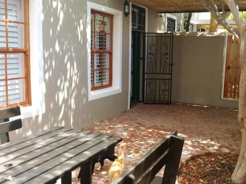 a wooden bench sitting in front of a house at Suites on 74 in Worcester