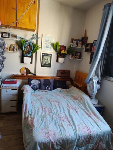 a bedroom with a bed with a blue comforter at Apt Flamengo colado metrô praias in Rio de Janeiro