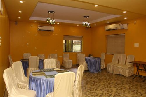 a room with a table and chairs in it at CHETAN INN HOTEL in Bhubaneshwar