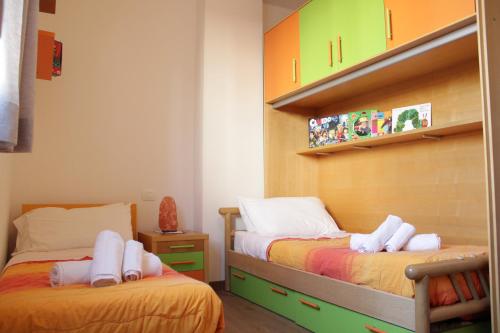 a bedroom with two beds with towels on them at Cisano Holiday Apartment in Bardolino