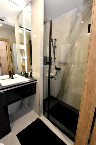 a bathroom with a shower and a sink at Apartamenty Blanca in Łeba