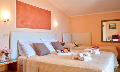 a bedroom with a bed with stuffed animals on it at Hotel La Pergola in Santa Maria di Castellabate