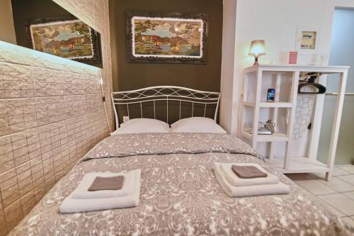 a bedroom with a bed with two towels on it at #Tyrtaiou Modern Design Studio in Mytilini
