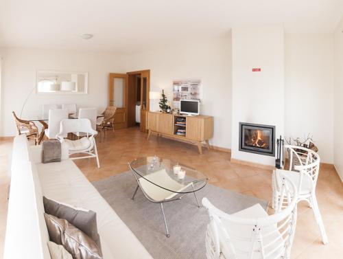 a living room with a couch and a fireplace at Apartamentos Villa T2 Vila Sagres in Sagres