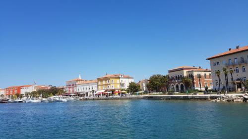 a view of a river with buildings and boats at Poreč old town, apartments in Poreč