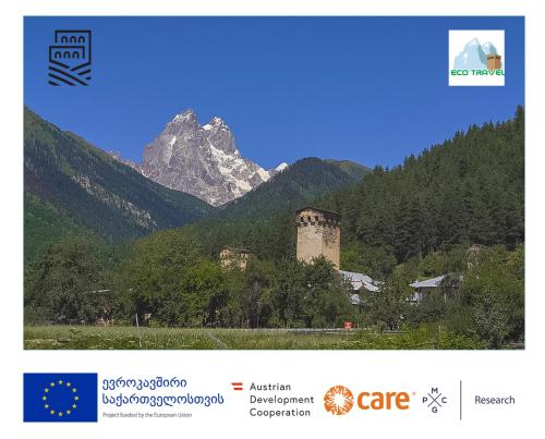 a picture of a mountain with a building in the foreground at Ecohouse Svaneti in Mestia