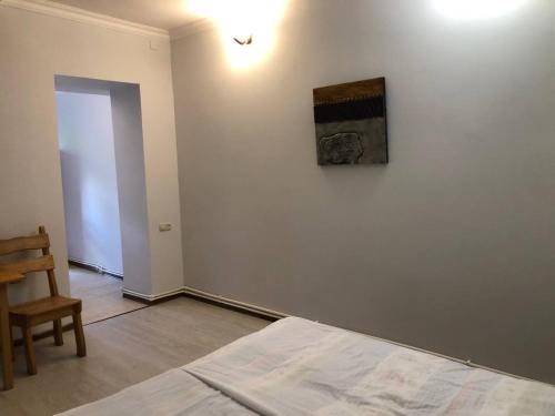 a bedroom with a bed and a painting on the wall at Dil Hill by Sam in Dilijan
