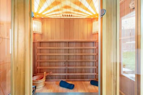 a walk in closet with wooden shelves and a window at LE CHILL Suite & SPA (Jacuzzi et Sauna privés) in Boissy-Saint-Léger