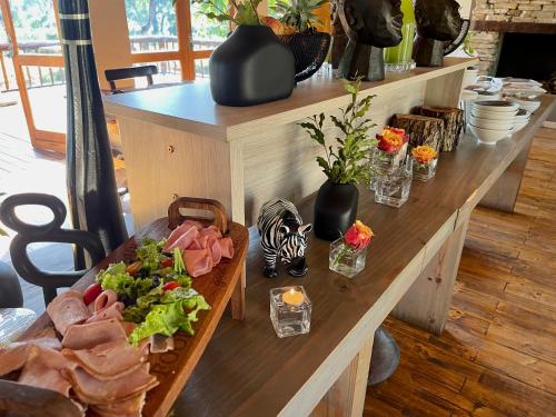 a table with food on it in a room at Karongwe - River Safari Lodge in Hoedspruit