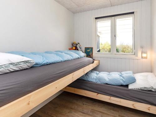 a bedroom with two beds and a window at Holiday home Vinderup XXV in Vinderup