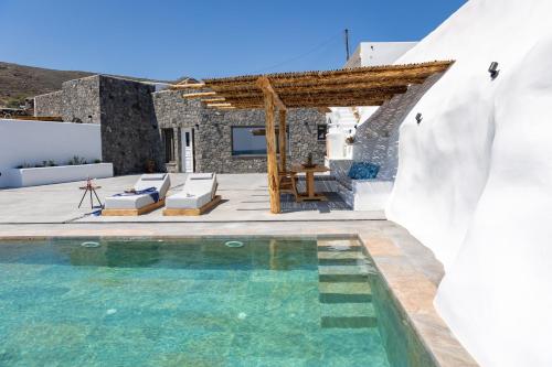 a villa with a swimming pool and a house at Casa di Mare Luxury Villas in Imerovigli