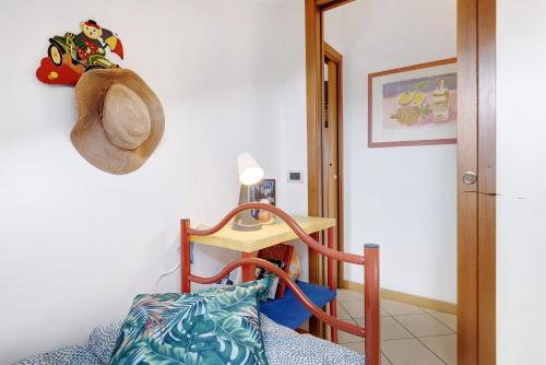 a room with a hat on the wall and a chair at Mansarda di Ponente in Caorle