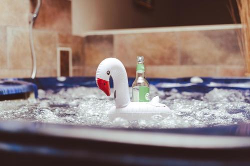 een plastic zwaan met een fles in een zwembad bij Hotel Villa Schwanebeck in Binz