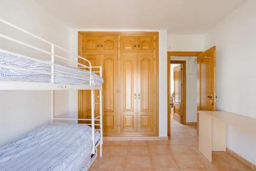 a bedroom with two bunk beds and a hallway at Habitación en Casa Vacacional Fuengirola in Fuengirola