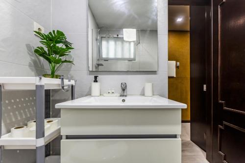 a bathroom with a white sink and a mirror at Hopstays - Gaia Cork House in Vila Nova de Gaia