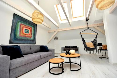 a living room with a couch and a hammock at Apartamenty Blanca in Łeba