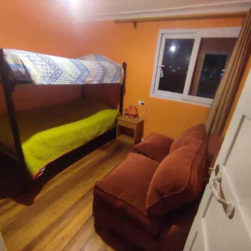 a living room with a bunk bed and a couch at Gatos de campo, tiernos y traviesos in Santiago