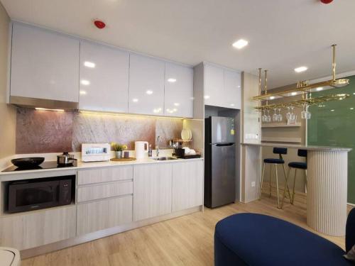 a kitchen with white cabinets and a counter top at At Huahin in Hua Hin