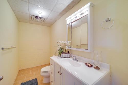 a bathroom with a sink and a toilet and a mirror at Mtn-View Ski Retreat with Grill in Seven Devils! in Seven Devils