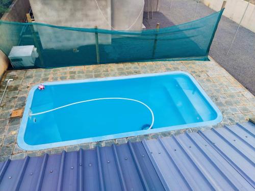 a blue swimming pool sitting on the ground at Privacy House in Triolet
