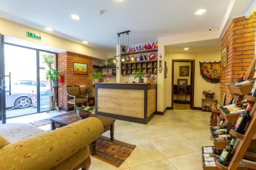 a lobby of a store with a counter and chairs at Elea Old Tbilisi Hotel in Tbilisi City