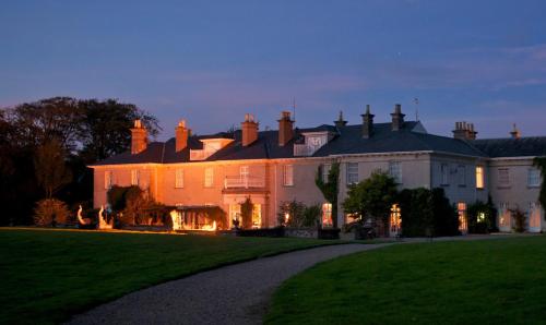 una casa grande con césped delante en Dunbrody Country House Hotel, en Arthurstown