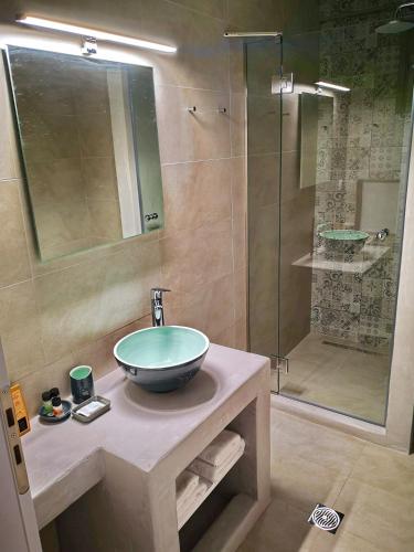 a bathroom with a sink and a shower at EmMi Houses in Nafplio