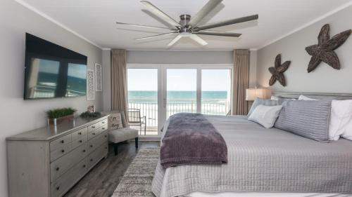 a bedroom with a bed and a ceiling fan at Total Remodel BEACHFRONT 5th Floor - 2 Bd & 2 Ba - Dunes of Panama in Panama City Beach