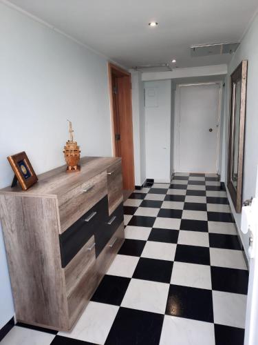 a hallway with a black and white checkered floor at Casa Velha in Matosinhos