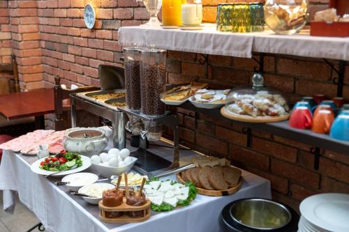 a buffet of food on a table with plates of food at Elea Old Tbilisi Hotel in Tbilisi City