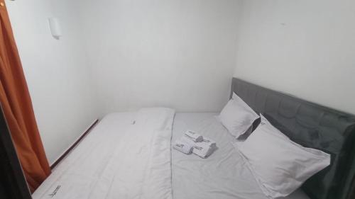 a bed in a room with two pillows on it at Rumah Gadang Tokama, Simarasok in Baso