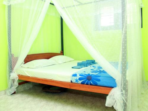 a bedroom with a bed with a canopy at Mirissa Harbour View in Mirissa