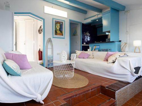 a living room with two beds and a couch at Lightbooking casa de playa Tenerife in Santa Cruz de Tenerife