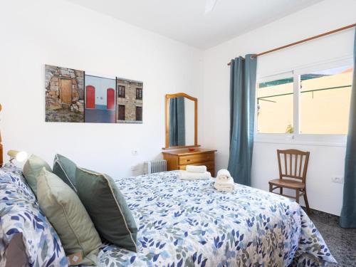 a bedroom with a bed and a chair and a window at Lightbooking Casa Maye Tenerife in Güimar