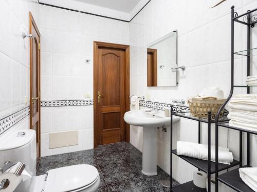 a white bathroom with a toilet and a sink at Lightbooking Casa Maye Tenerife in Güimar
